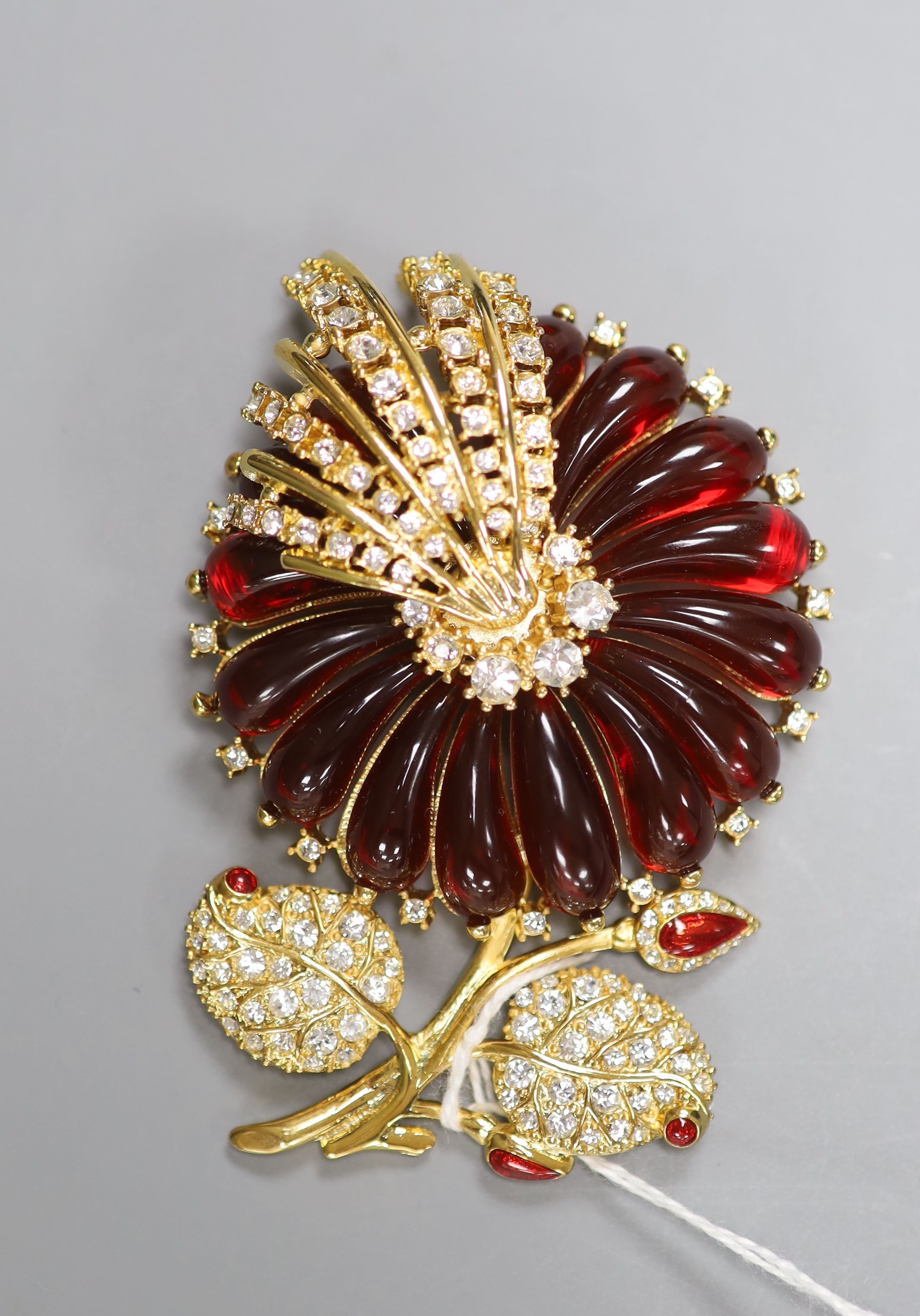 Four items of designer costume jewellery, including a Camrose & Kross 'Jacqueline Kennedy' reproduction flower brooch